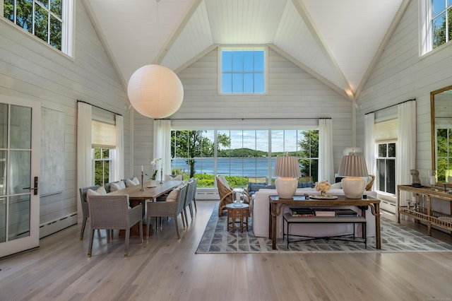 7 Hanna Ln, Essex, CT 06426 - dining space featuring high vaulted ceiling, wood walls, healthy amount of natural light, wood finished floors, and baseboard heating