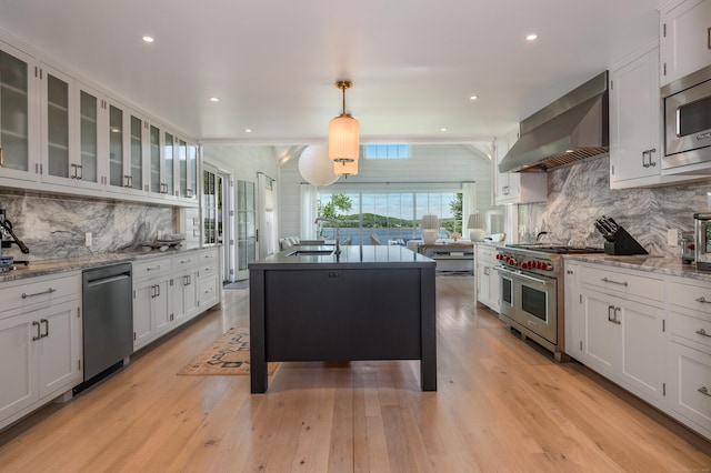 7 Hanna Ln, Essex, CT 06426 - kitchen featuring stainless steel appliances, wall chimney range hood, decorative backsplash, white cabinetry, and recessed lighting