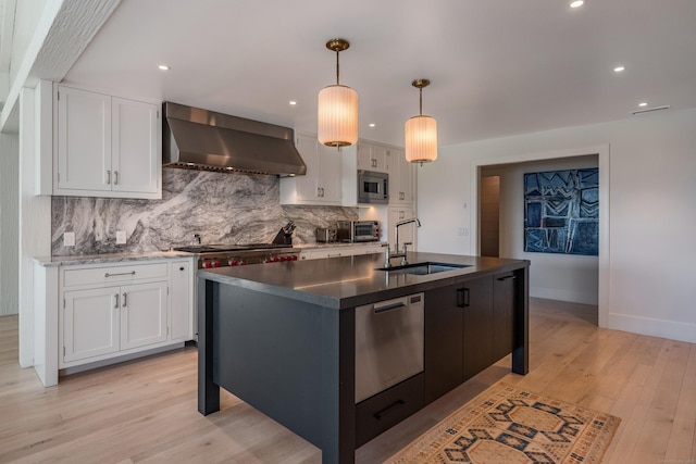 7 Hanna Ln, Essex, CT 06426 - kitchen featuring wall chimney range hood, stainless steel appliances, tasteful backsplash, white cabinetry, and recessed lighting