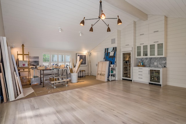 7 Hanna Ln, Essex, CT 06426 - living room with beverage cooler, wood finished floors, beam ceiling, a dry bar, and high vaulted ceiling