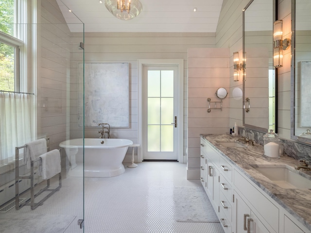 7 Hanna Ln, Essex, CT 06426 - bathroom featuring double vanity, a freestanding bath, healthy amount of natural light, and wooden walls
