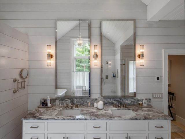 7 Hanna Ln, Essex, CT 06426 - full bath featuring double vanity, wooden walls, tiled shower, and wood finished floors
