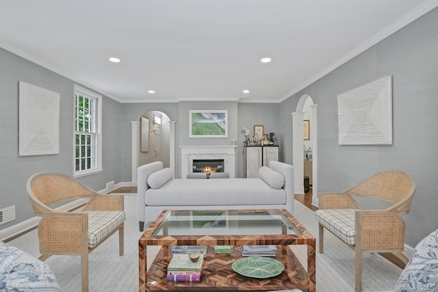 49 Dogwood Ln, New Canaan, CT 06840 - living room with crown molding, baseboards, recessed lighting, a fireplace, and arched walkways