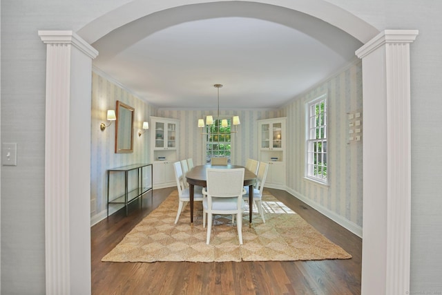 49 Dogwood Ln, New Canaan, CT 06840 - dining room with arched walkways, wallpapered walls, wood finished floors, baseboards, and ornamental molding