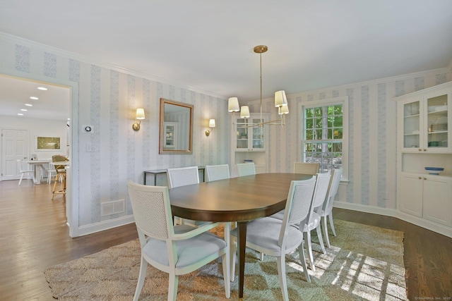 49 Dogwood Ln, New Canaan, CT 06840 - dining space with wallpapered walls, wood finished floors, a chandelier, ornamental molding, and baseboards