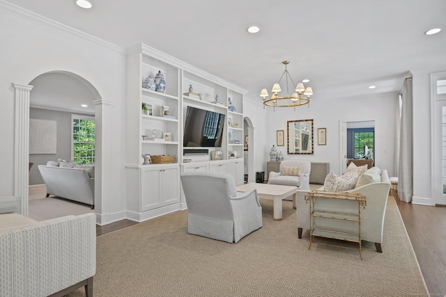 49 Dogwood Ln, New Canaan, CT 06840 - living area featuring arched walkways, recessed lighting, wood finished floors, a chandelier, and ornamental molding