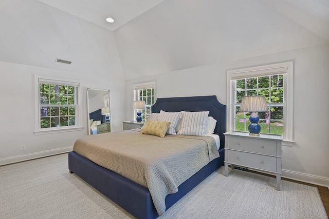 49 Dogwood Ln, New Canaan, CT 06840 - bedroom with lofted ceiling, baseboards, multiple windows, and wood finished floors