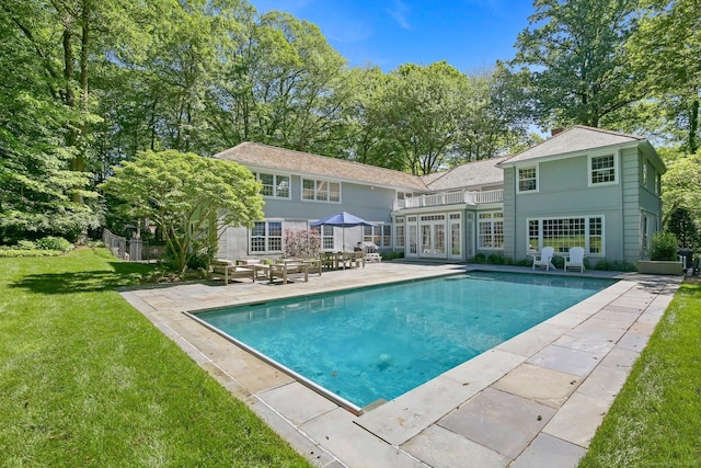 49 Dogwood Ln, New Canaan, CT 06840 - outdoor pool featuring a patio, a lawn, and french doors