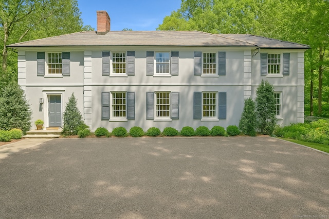 49 Dogwood Ln, New Canaan, CT 06840 - colonial inspired home with a chimney and stucco siding