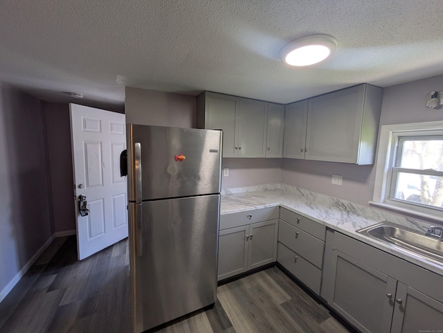 386 Platt Ave, West Haven, CT 06516 - kitchen with freestanding refrigerator, gray cabinets, dark wood-type flooring, a textured ceiling, and a sink