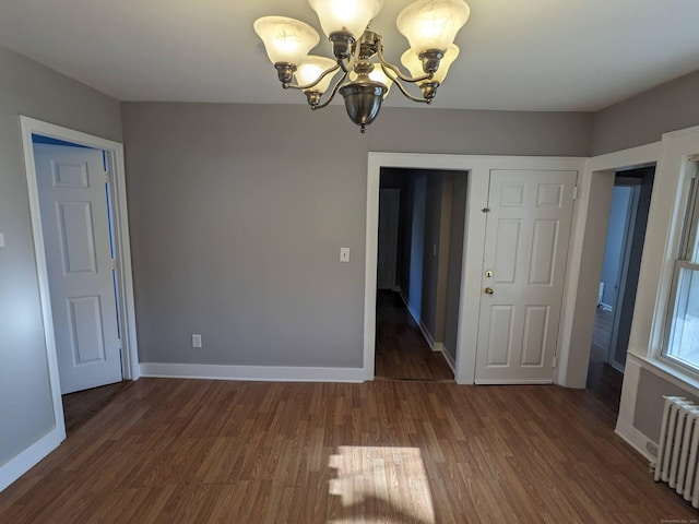 386 Platt Ave, West Haven, CT 06516 - unfurnished dining area featuring radiator heating unit, a chandelier, wood finished floors, and baseboards