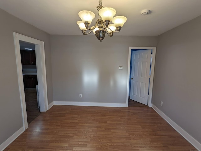 386 Platt Ave, West Haven, CT 06516 - unfurnished dining area featuring a chandelier, wood finished floors, and baseboards