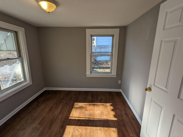 386 Platt Ave, West Haven, CT 06516 - unfurnished room with dark wood-style flooring, baseboards, and a textured ceiling