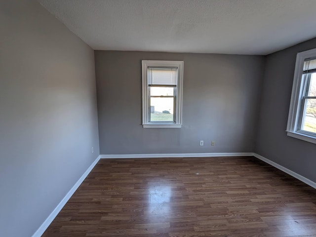 386 Platt Ave, West Haven, CT 06516 - empty room featuring dark wood-style flooring, a textured ceiling, and baseboards
