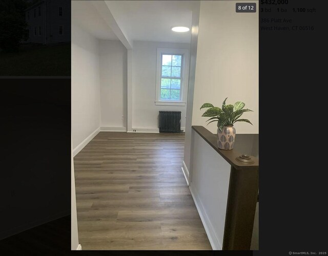 386 Platt Ave, West Haven, CT 06516 - hallway with radiator heating unit, wood finished floors, and baseboards