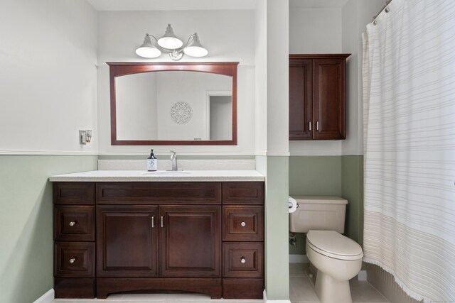 bathroom featuring toilet, vanity, baseboards, and a shower with curtain