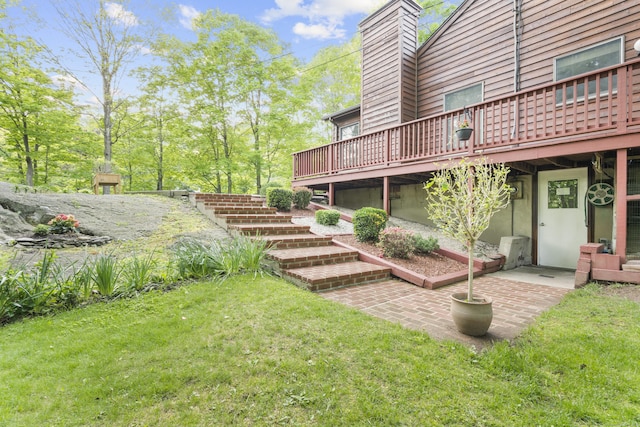 view of grassy yard featuring stairs and a deck