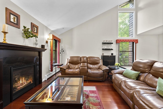 living area with high vaulted ceiling, wood finished floors, a baseboard heating unit, and a glass covered fireplace