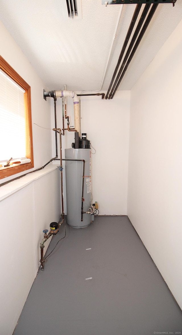 utility room featuring water heater