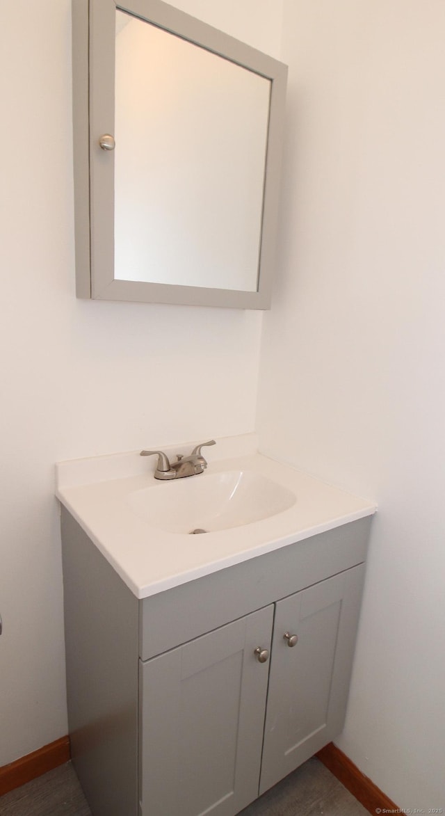 bathroom with vanity and baseboards