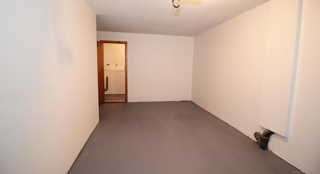 unfurnished room with concrete flooring