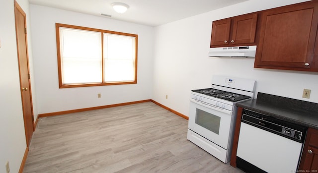 kitchen with white appliances, under cabinet range hood, dark countertops, light wood-style floors, and baseboards