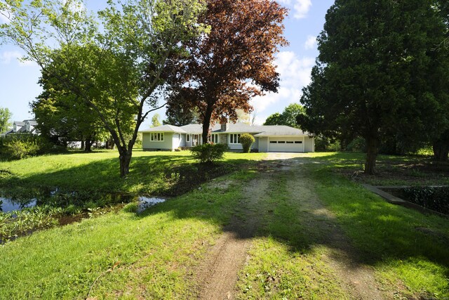 241 Clarks Falls Rd, North Stonington, CT 06359 - ranch-style house featuring dirt driveway, an attached garage, and a front yard