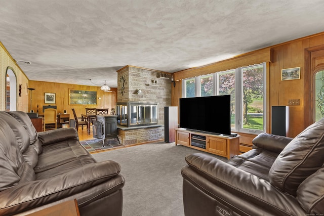 241 Clarks Falls Rd, North Stonington, CT 06359 - carpeted living area featuring wooden walls and a textured ceiling