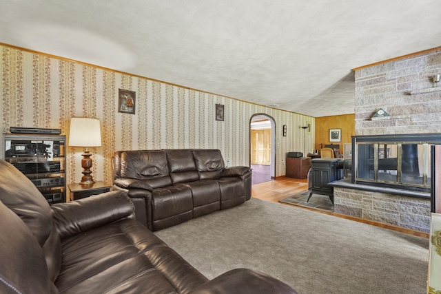 241 Clarks Falls Rd, North Stonington, CT 06359 - living room with arched walkways, wallpapered walls, and a stone fireplace