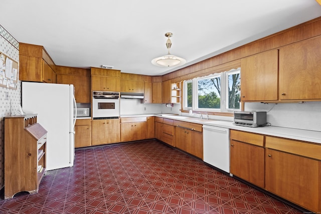 241 Clarks Falls Rd, North Stonington, CT 06359 - kitchen with white appliances, dark floors, a sink, light countertops, and under cabinet range hood