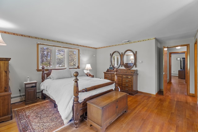 241 Clarks Falls Rd, North Stonington, CT 06359 - bedroom featuring light wood-style flooring, baseboard heating, and baseboards