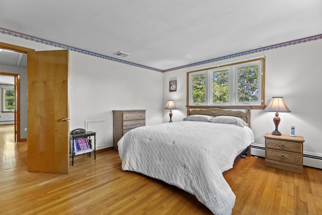 241 Clarks Falls Rd, North Stonington, CT 06359 - bedroom with a baseboard radiator, light wood-style floors, baseboard heating, baseboards, and attic access