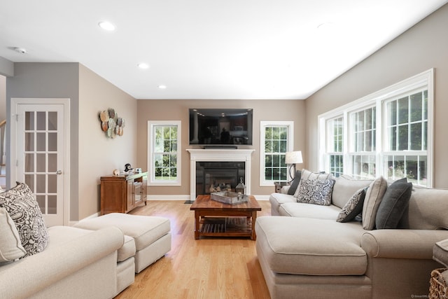 123 Cobblestone Dr, Southington, CT 06479 - living room featuring light wood-type flooring, a glass covered fireplace, recessed lighting, and baseboards