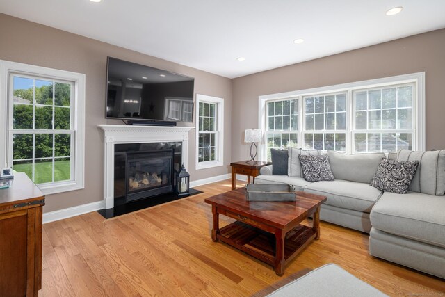 123 Cobblestone Dr, Southington, CT 06479 - living area featuring light wood-style floors, baseboards, recessed lighting, and a fireplace with flush hearth