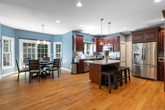 123 Cobblestone Dr, Southington, CT 06479 - kitchen featuring appliances with stainless steel finishes, light countertops, light wood-type flooring, a kitchen breakfast bar, and recessed lighting