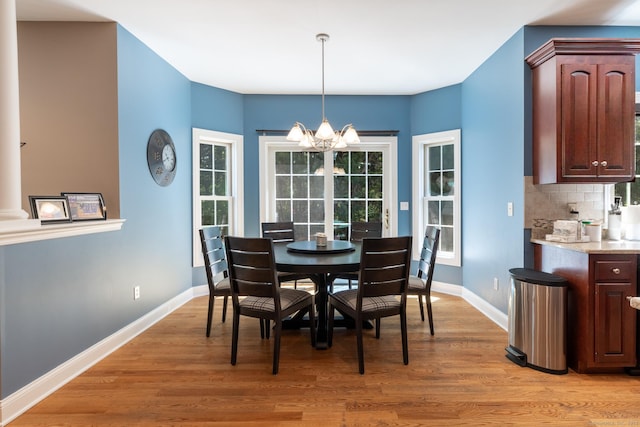 123 Cobblestone Dr, Southington, CT 06479 - dining room with a chandelier, light wood finished floors, and baseboards