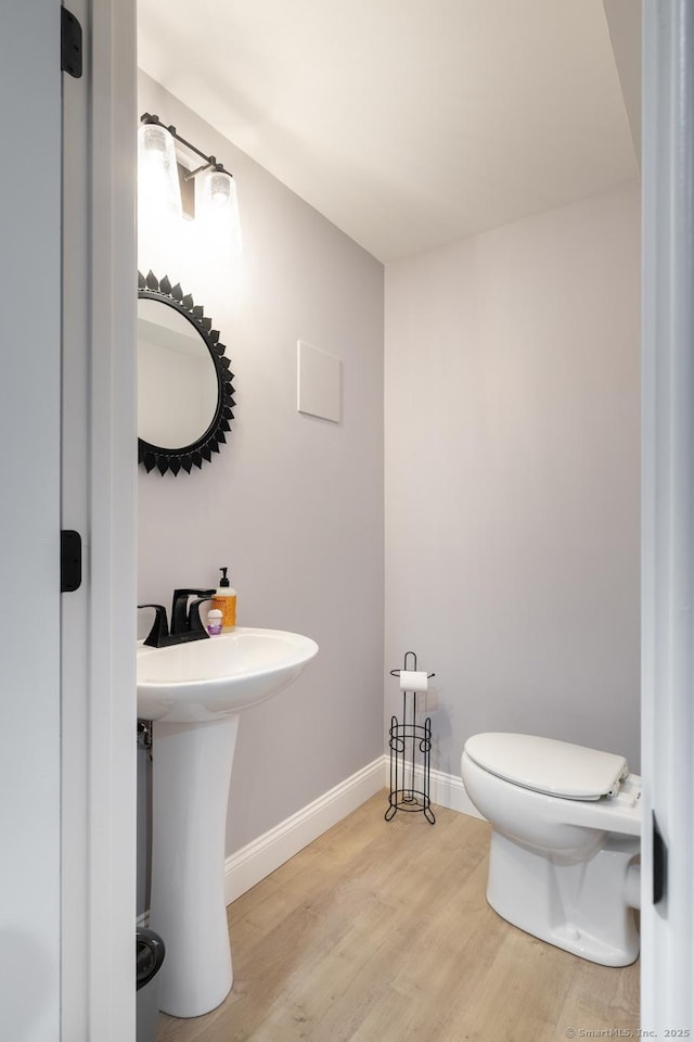 123 Cobblestone Dr, Southington, CT 06479 - half bathroom with wood finished floors, toilet, and baseboards