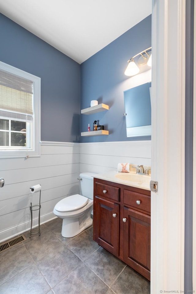 123 Cobblestone Dr, Southington, CT 06479 - half bath with a wainscoted wall, toilet, tile patterned flooring, and vanity