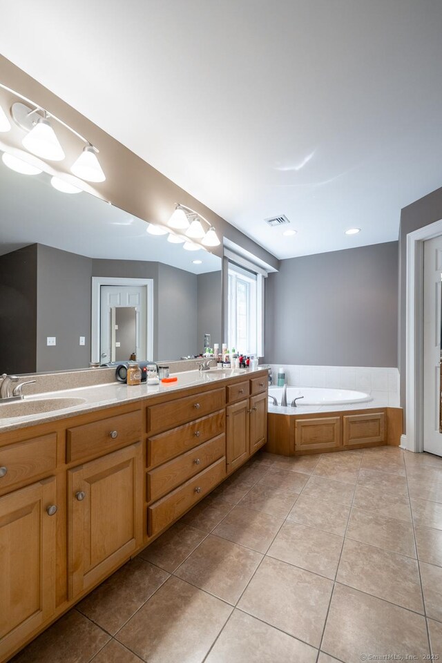 123 Cobblestone Dr, Southington, CT 06479 - bathroom featuring tile patterned flooring, double vanity, and a bath