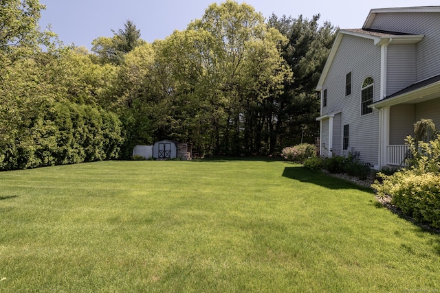 123 Cobblestone Dr, Southington, CT 06479 - view of grassy yard featuring a storage shed and an outdoor structure