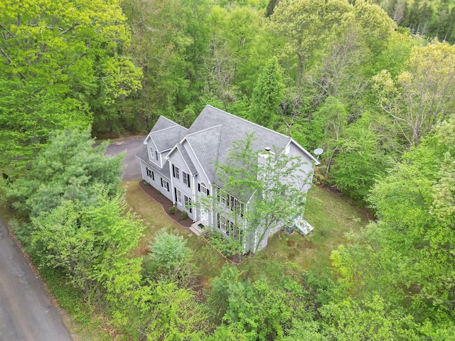 view of subject property featuring a heavily wooded area