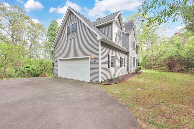 view of home's exterior with driveway, a garage, a lawn, and a shingled roof