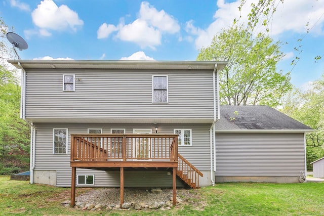 rear view of house featuring a deck and a lawn