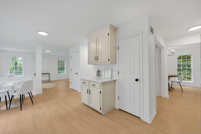 kitchen with light wood-type flooring, light countertops, baseboards, a chandelier, and recessed lighting