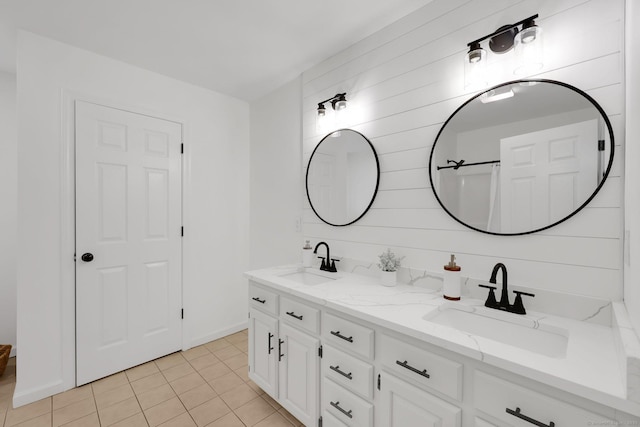 bathroom featuring double vanity, tile patterned flooring, backsplash, and baseboards