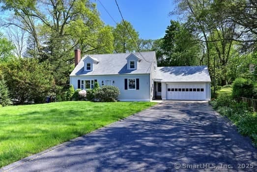 32 Lenox Ave, Norwalk, CT 06854 - new england style home with asphalt driveway, an attached garage, a front yard, and a chimney