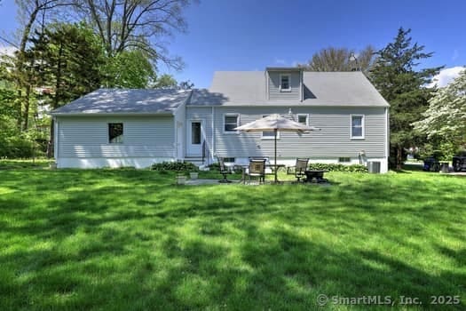 32 Lenox Ave, Norwalk, CT 06854 - back of house featuring a lawn and entry steps