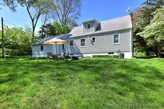32 Lenox Ave, Norwalk, CT 06854 - back of house with a chimney and a yard