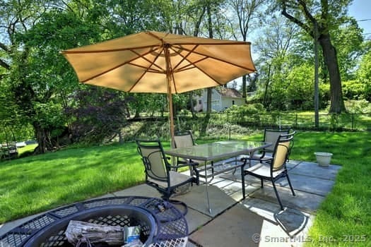 32 Lenox Ave, Norwalk, CT 06854 - view of patio / terrace featuring an outdoor fire pit, outdoor dining space, and view of scattered trees