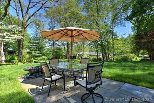 32 Lenox Ave, Norwalk, CT 06854 - view of patio with outdoor dining area and view of wooded area